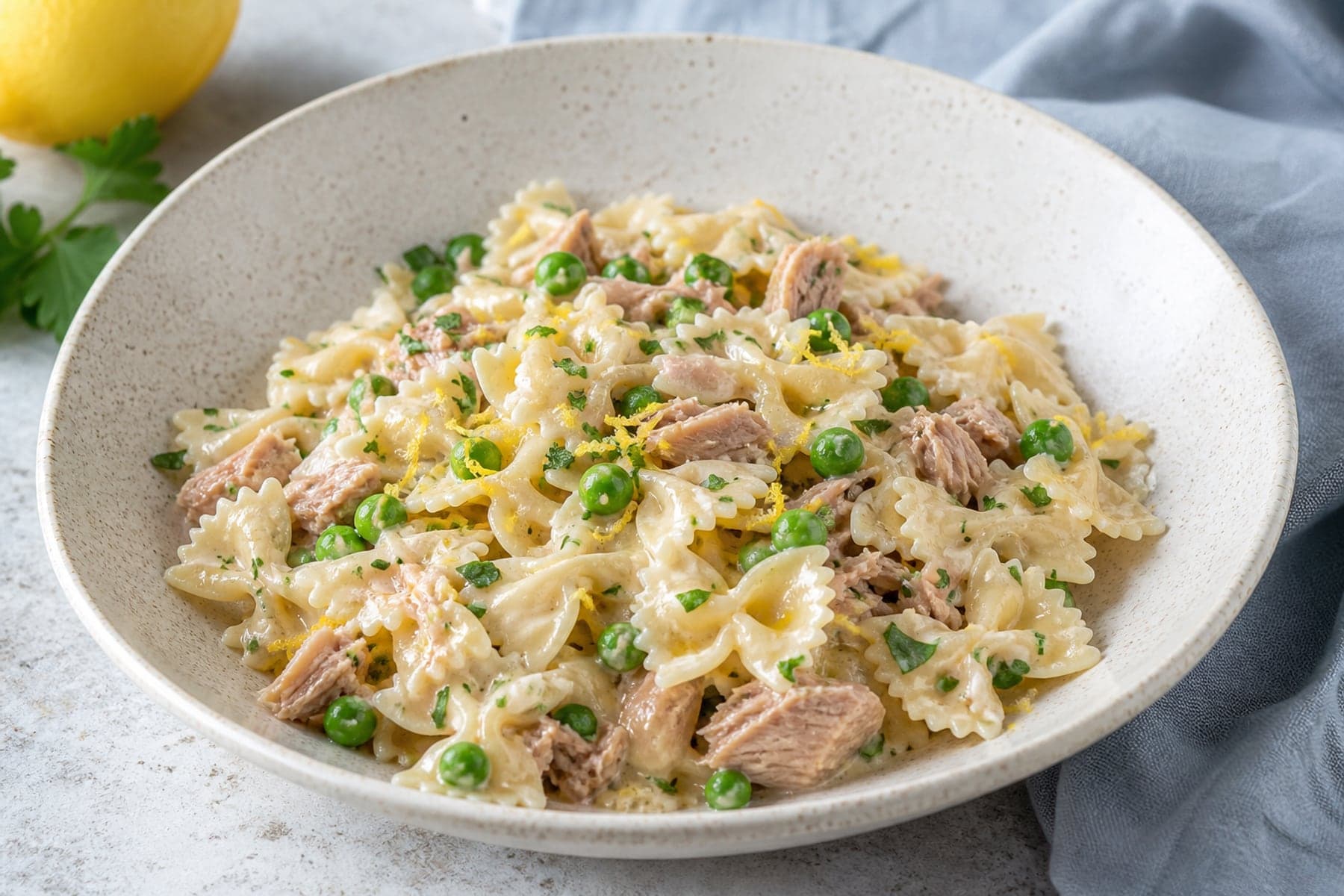 Farfalle in lemon cream sauce with tuna flakes peas and parsley