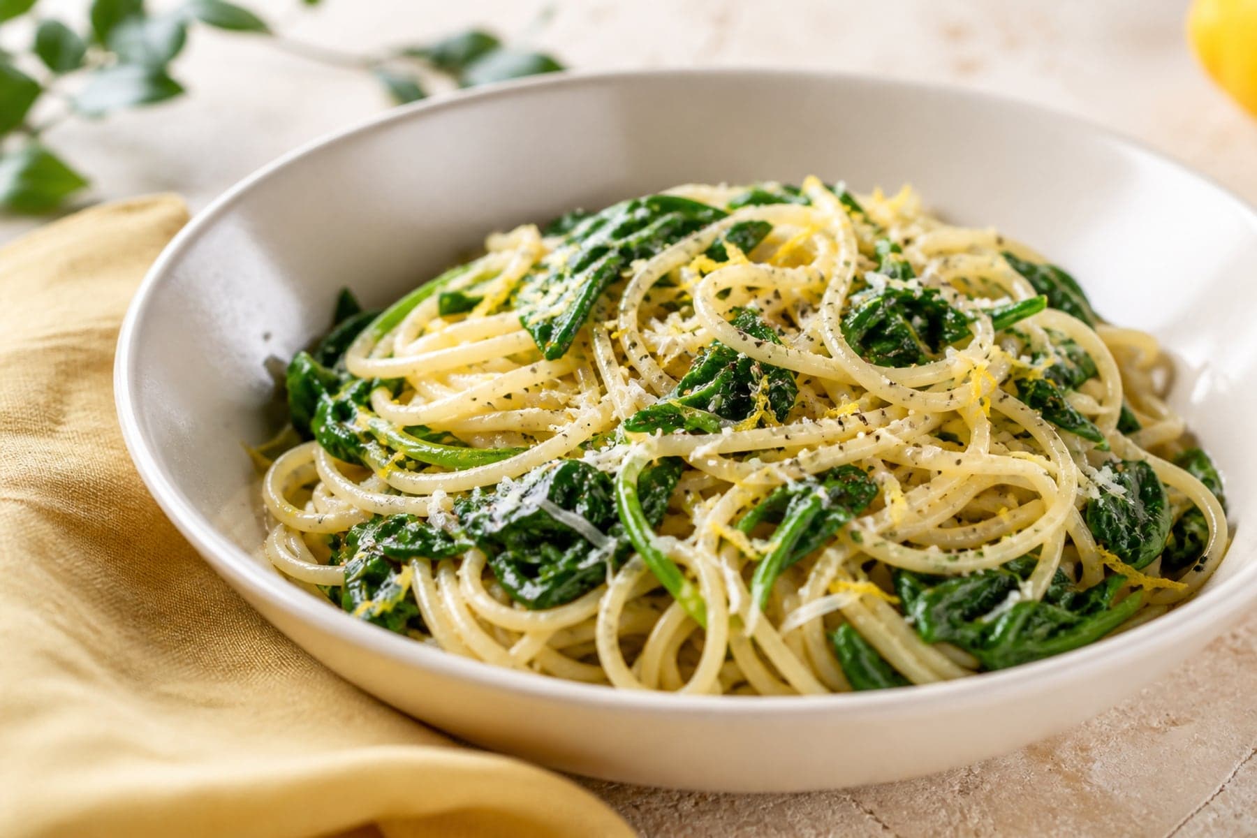 Spaghetti with wilted baby spinach lemon zest Parmesan and black pepper