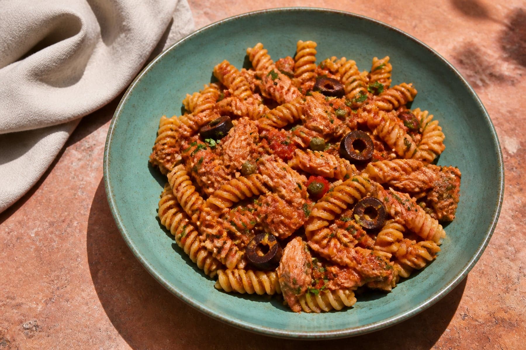 Fusilli with tuna flakes capers olives and spicy tomato sauce