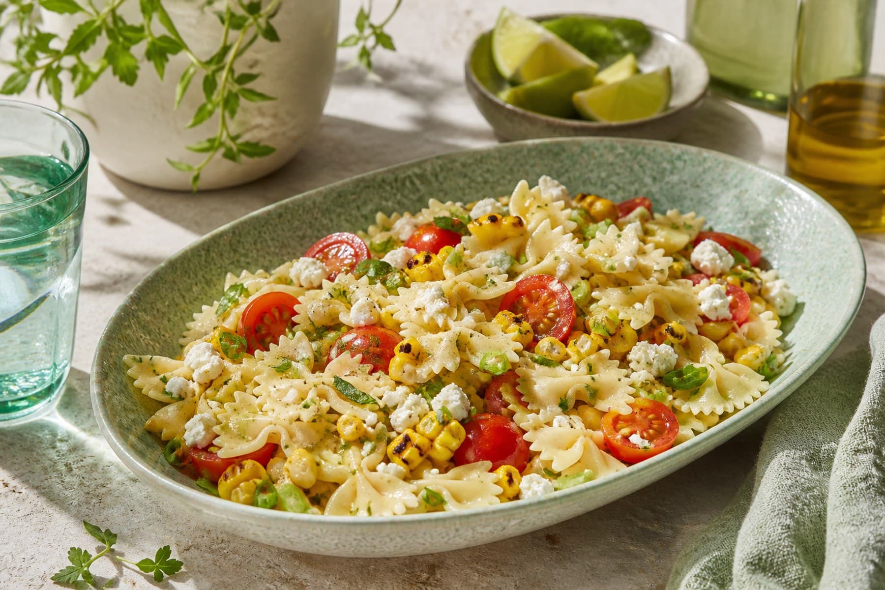 Farfalle salad with charred sweetcorn feta tomato spring onion and herbs
