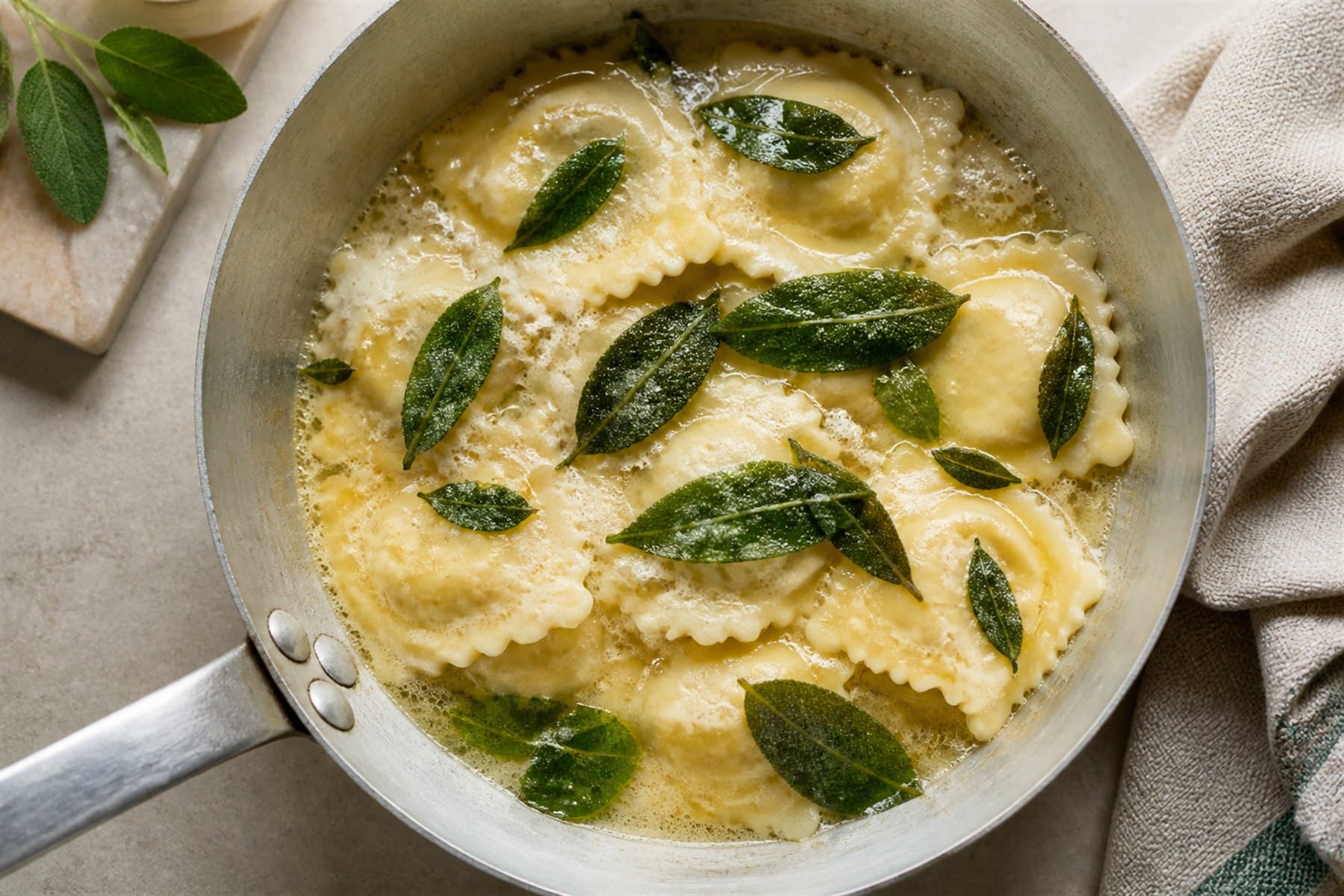 Foaming brown butter and crisp sage leaves spooned over ravioli