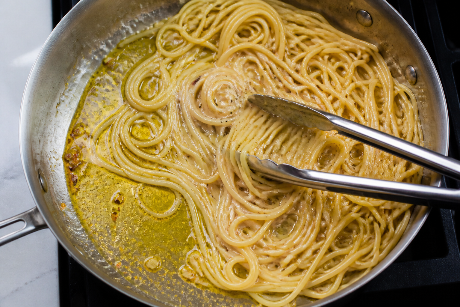 Spaghetti sauce with separated oil at the pan edge and a glossier emulsified centre